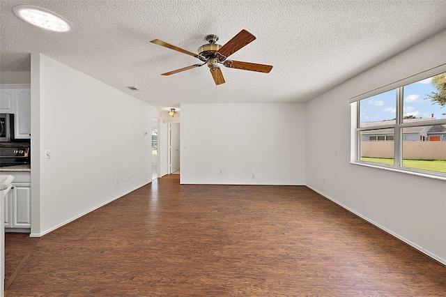 unfurnished living room featuring a textured ceiling, ceiling fan, and dark hardwood / wood-style floors