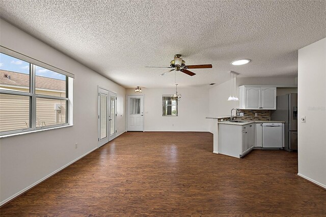 kitchen with stainless steel fridge, tasteful backsplash, sink, dishwasher, and white cabinets