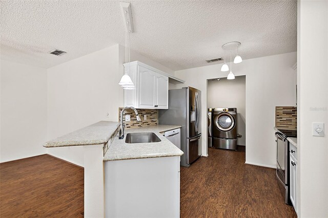 kitchen featuring hanging light fixtures, kitchen peninsula, decorative backsplash, a kitchen bar, and white cabinetry