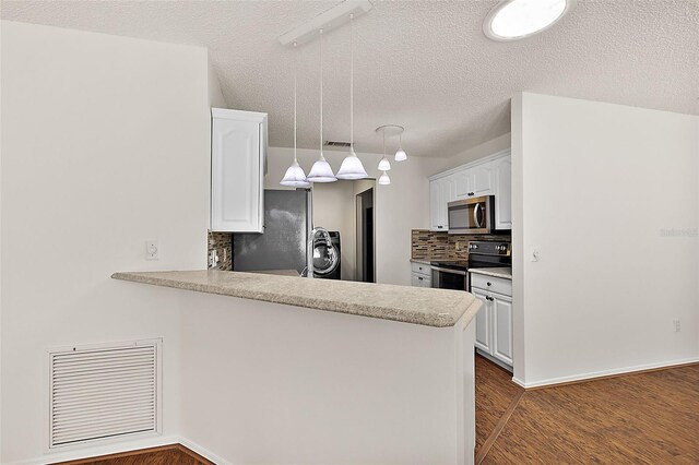 kitchen featuring kitchen peninsula, white cabinetry, hanging light fixtures, and appliances with stainless steel finishes