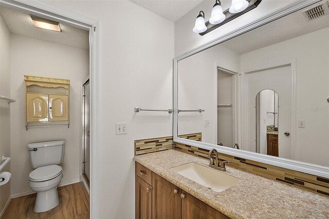 bathroom featuring vanity, a textured ceiling, and tasteful backsplash