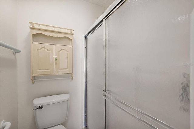 bathroom with an enclosed shower and toilet