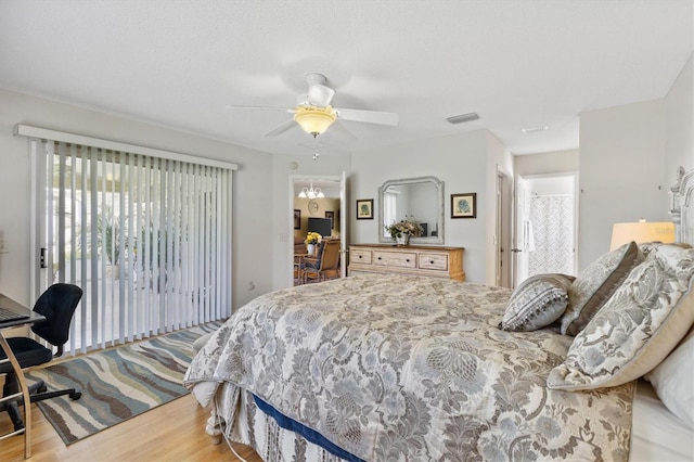 bedroom featuring hardwood / wood-style flooring, access to exterior, and ceiling fan