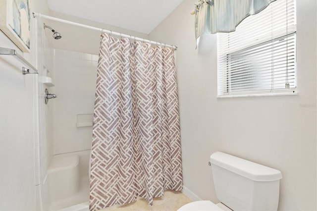 bathroom with curtained shower, tile patterned floors, and toilet