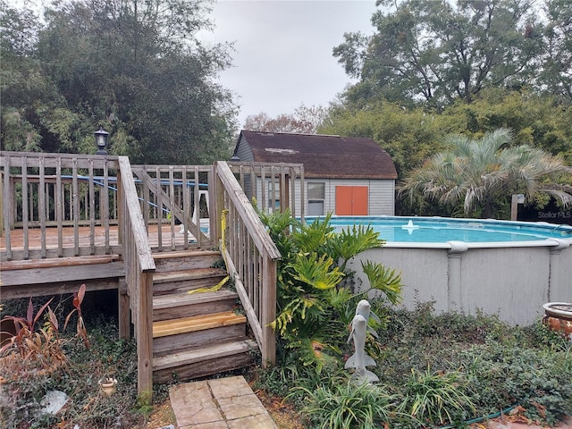 pool featuring an outbuilding and a wooden deck