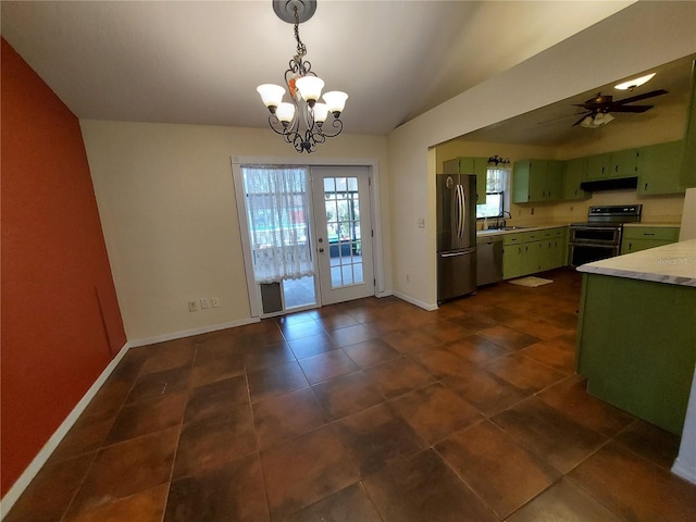 kitchen with green cabinets, light countertops, baseboards, appliances with stainless steel finishes, and ventilation hood