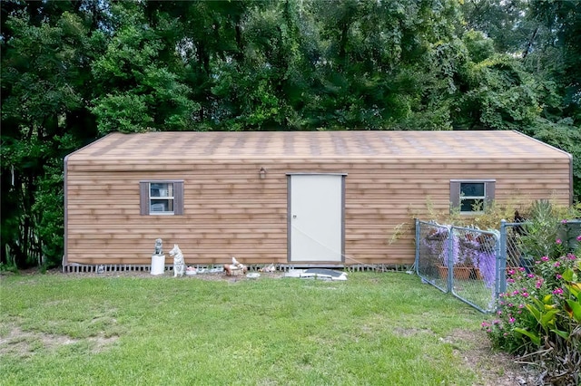 view of outbuilding featuring an outdoor structure and fence
