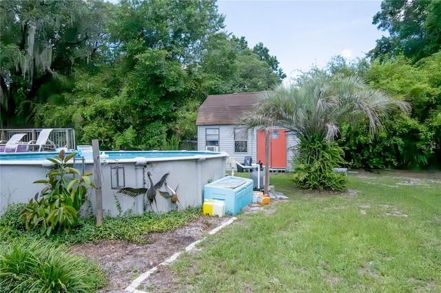 view of yard featuring an outdoor pool and an outbuilding