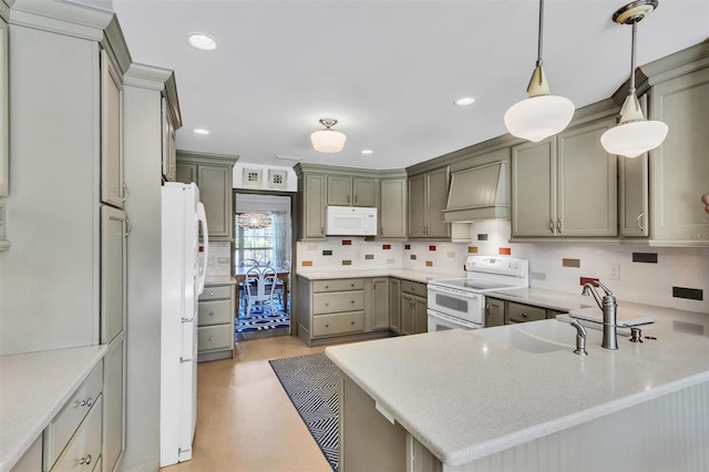 kitchen with pendant lighting, white appliances, custom range hood, and a peninsula