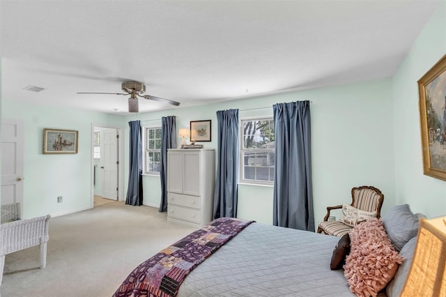 bedroom featuring baseboards, a ceiling fan, visible vents, and light colored carpet