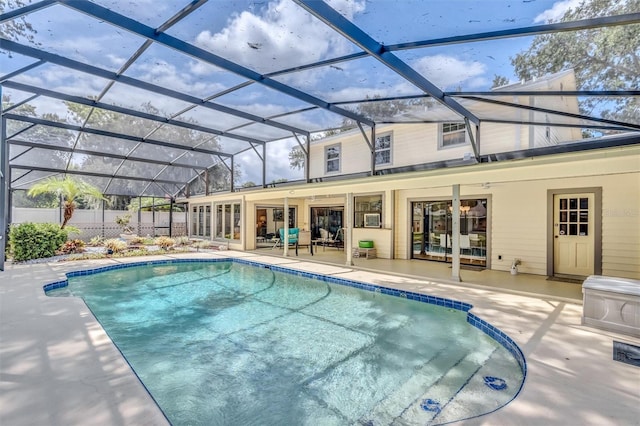 view of swimming pool with a fenced in pool, a lanai, a patio area, and fence