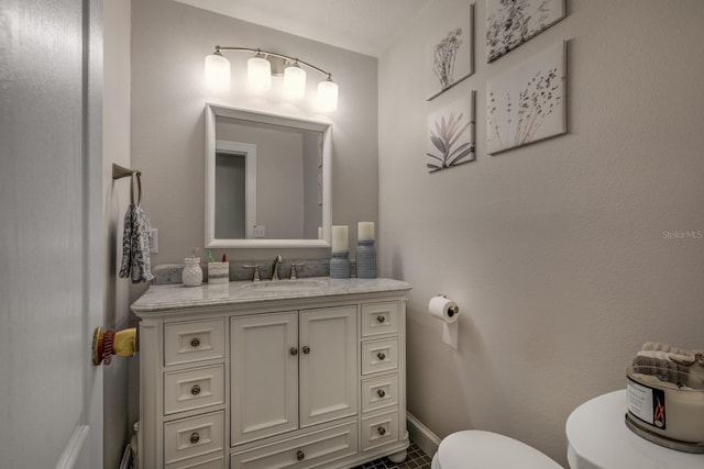 bathroom with tile patterned floors, vanity, and toilet