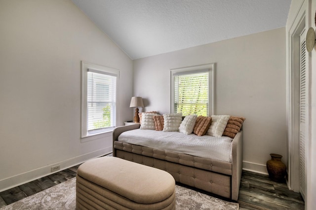 sitting room with vaulted ceiling and dark wood-type flooring