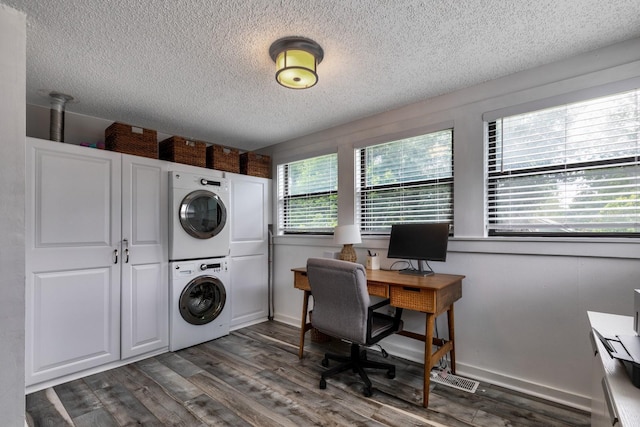 clothes washing area featuring a textured ceiling, dark hardwood / wood-style floors, and stacked washer / dryer