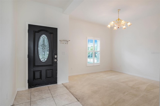 foyer entrance featuring light tile patterned floors and a chandelier