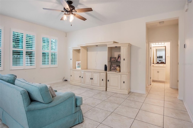 tiled living room with ceiling fan