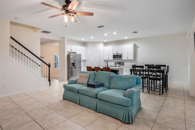 living room featuring light tile patterned floors and ceiling fan