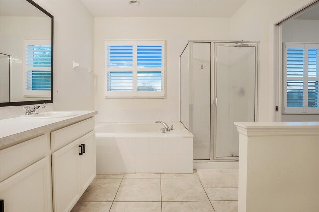 bathroom with shower with separate bathtub, vanity, and tile patterned floors