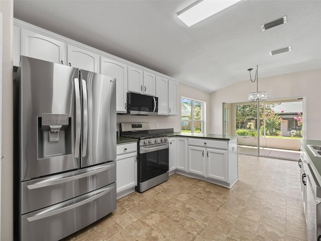 kitchen with white cabinets, hanging light fixtures, vaulted ceiling, kitchen peninsula, and stainless steel appliances