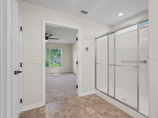 bathroom featuring ceiling fan and walk in shower