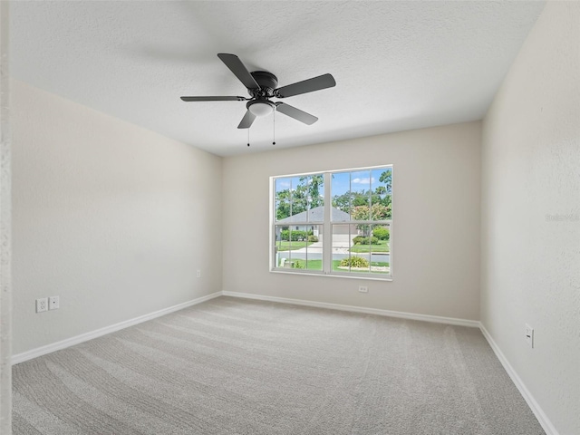 empty room featuring carpet, a textured ceiling, and ceiling fan