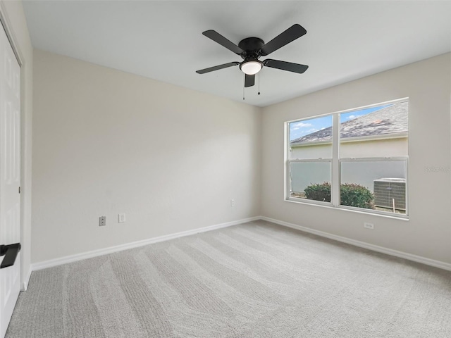 carpeted spare room with ceiling fan