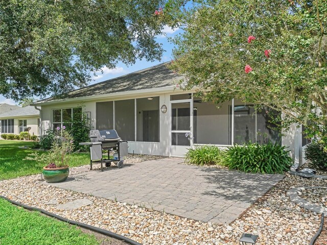 back of property featuring a patio area and a sunroom