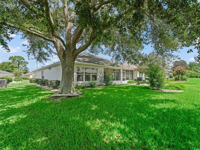 rear view of property with a lawn