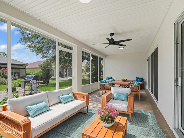 sunroom featuring ceiling fan and a healthy amount of sunlight