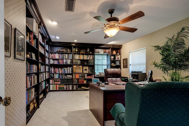 office space featuring light tile patterned flooring, a textured ceiling, and ceiling fan