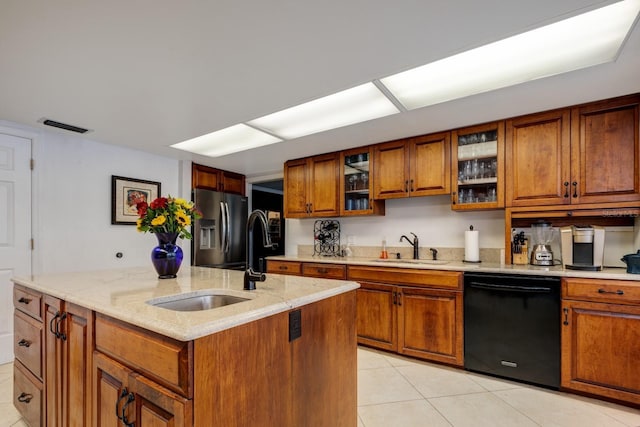 kitchen with light tile patterned flooring, stainless steel refrigerator with ice dispenser, sink, dishwasher, and a kitchen island