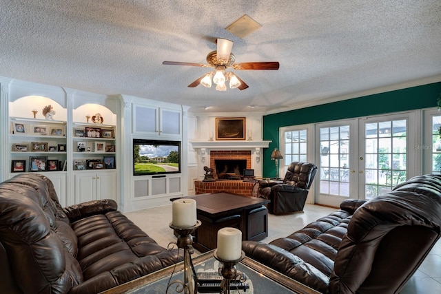 living room with a textured ceiling, a fireplace, french doors, and ceiling fan