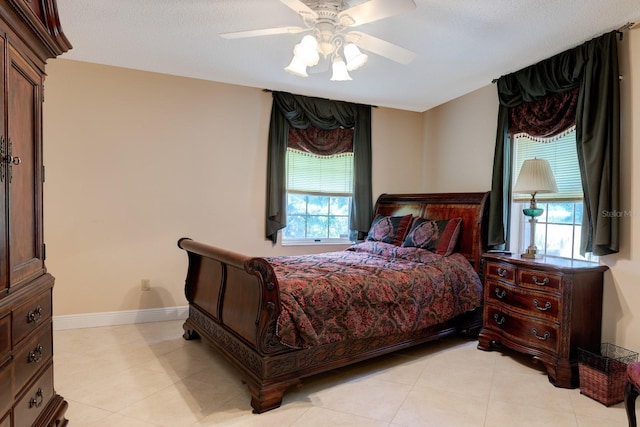 bedroom featuring light tile patterned flooring and ceiling fan