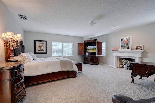 bedroom featuring a textured ceiling and light colored carpet