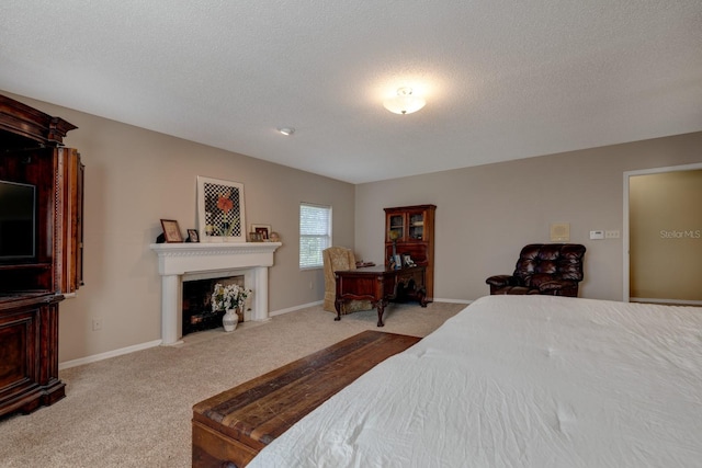 bedroom featuring light carpet and a textured ceiling