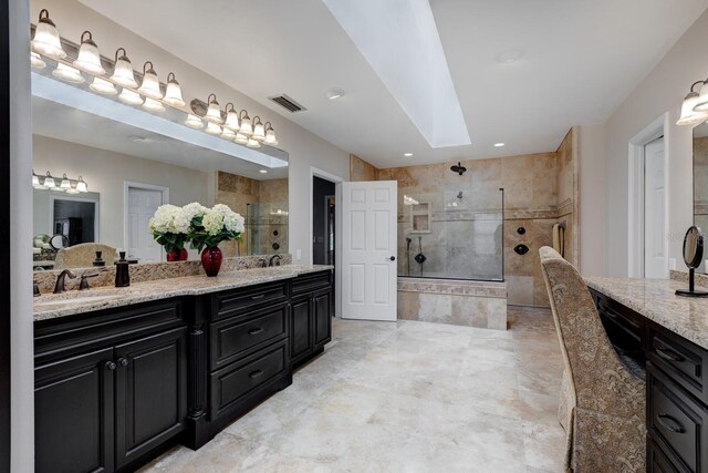 bathroom featuring vanity, walk in shower, and tile patterned flooring