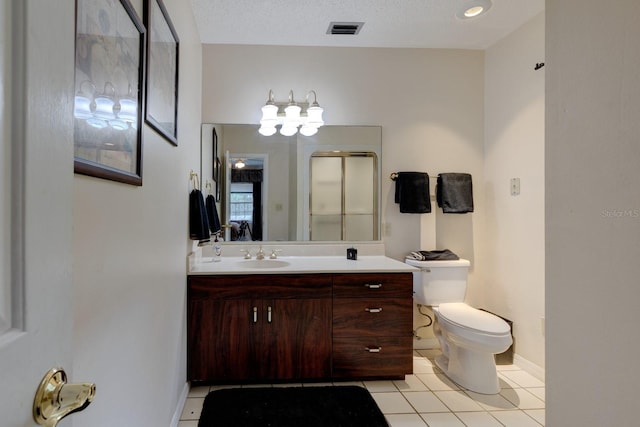 bathroom with toilet, an enclosed shower, a textured ceiling, vanity, and tile patterned flooring