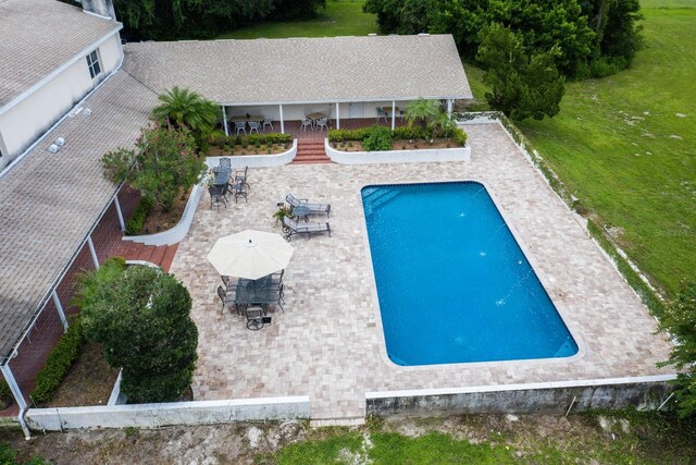 view of swimming pool featuring a patio and a lawn