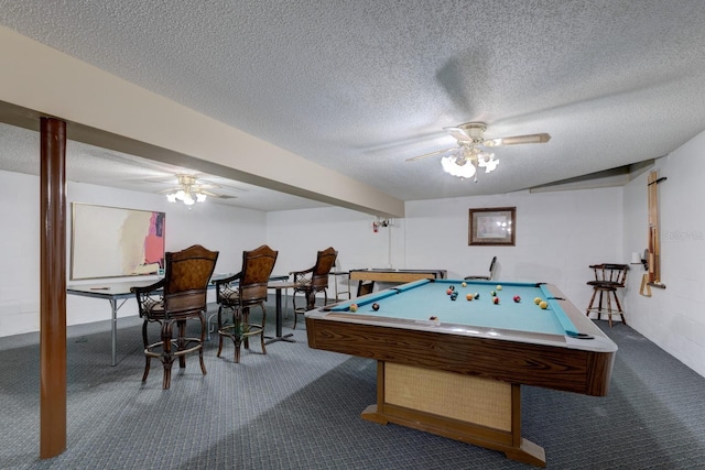 recreation room with pool table, dark colored carpet, and a textured ceiling