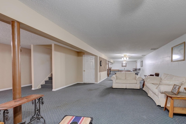 living room with dark carpet and a textured ceiling