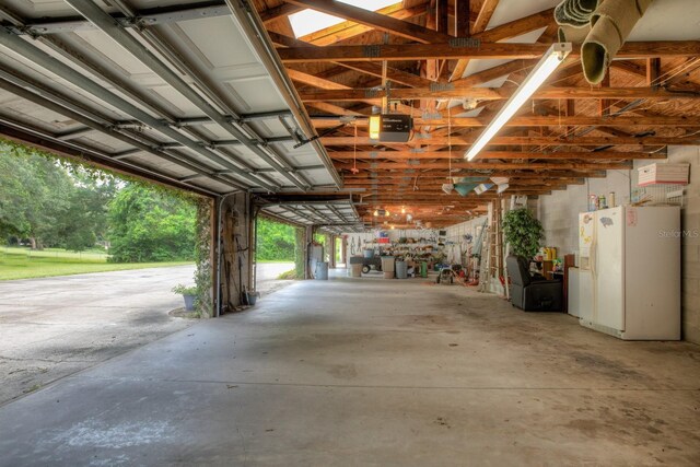 garage featuring white fridge with ice dispenser