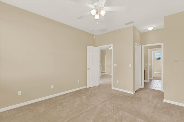 unfurnished bedroom featuring ceiling fan and light carpet