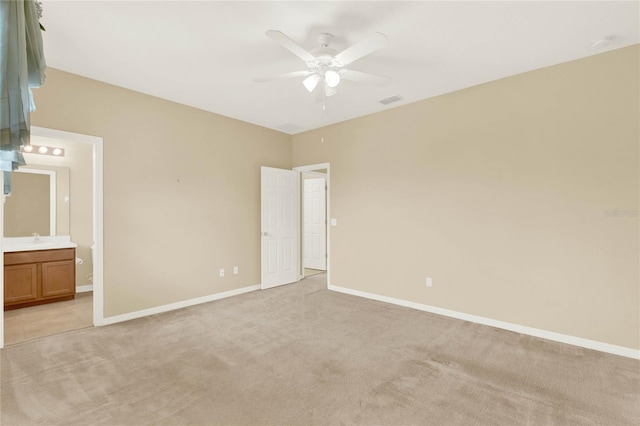 carpeted spare room with ceiling fan and sink