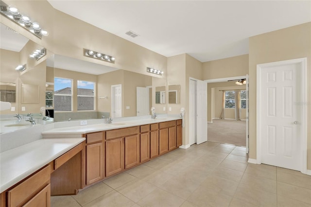 bathroom with tile patterned floors, ceiling fan, and plenty of natural light