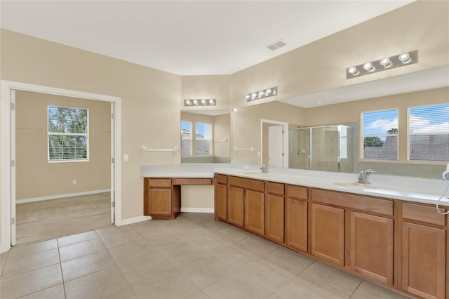 bathroom featuring tile patterned flooring, vanity, and a shower with shower door