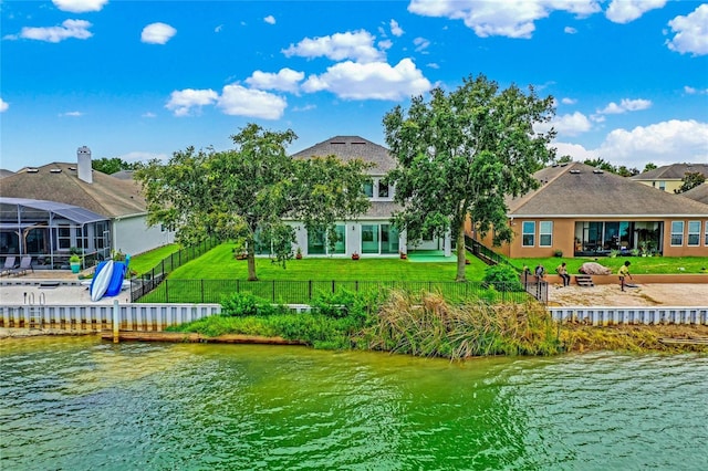 exterior space with a water view and a lawn