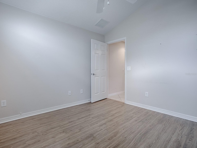 unfurnished room with light wood-type flooring, vaulted ceiling, and ceiling fan