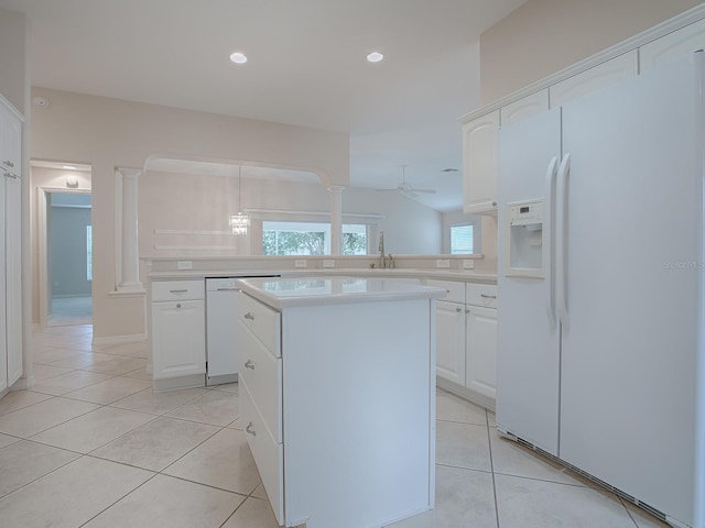 kitchen with white cabinets, white appliances, a center island, and ceiling fan