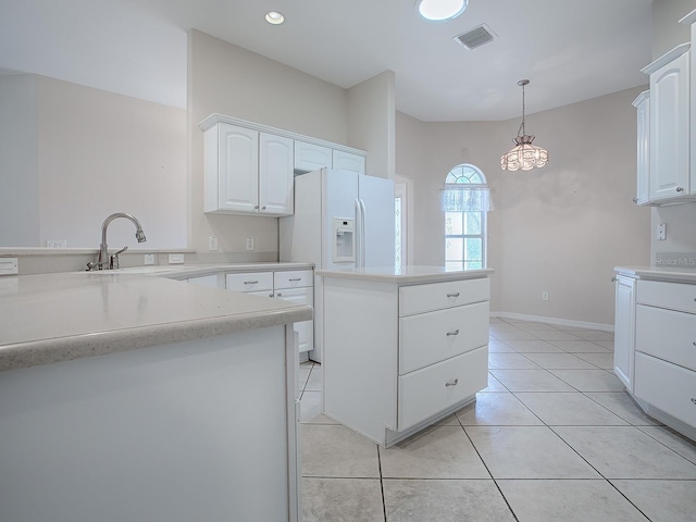 kitchen featuring white cabinets, a center island, sink, and hanging light fixtures