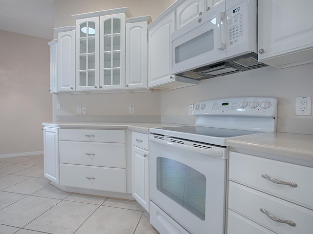 kitchen with white cabinets, white appliances, and light tile patterned floors